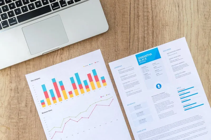 Femme en reconversion professionnelle relisant son CV réécrit en version compétences, adapté à un nouveau secteur d'activité